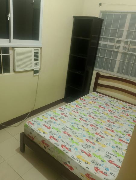 Bedroom with bed, shelf and aircon